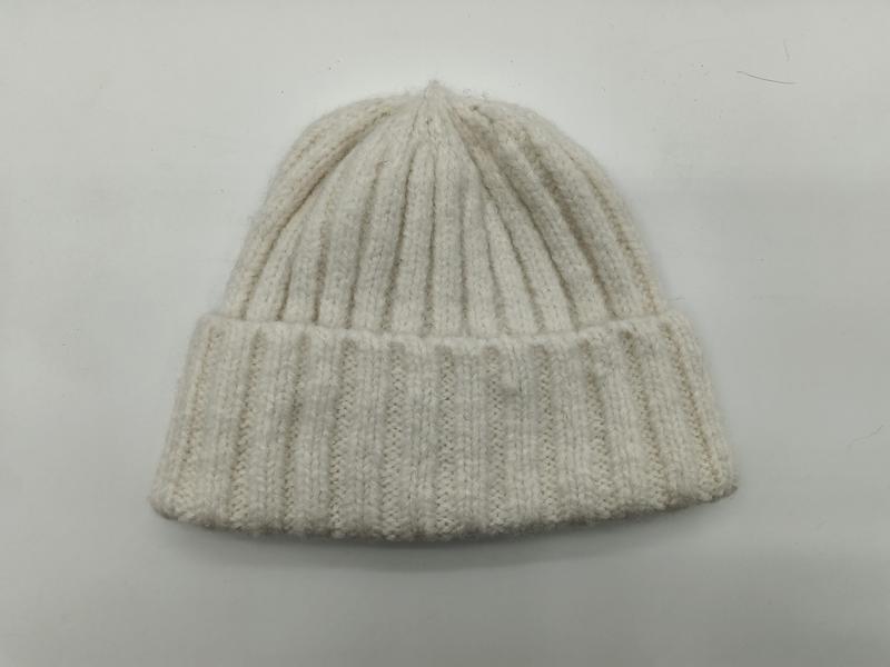 Kremowa czapka beanie z grubym prążkowanym splotem, zimowa czapka typu oversize w kolorze złamanej bieli.
