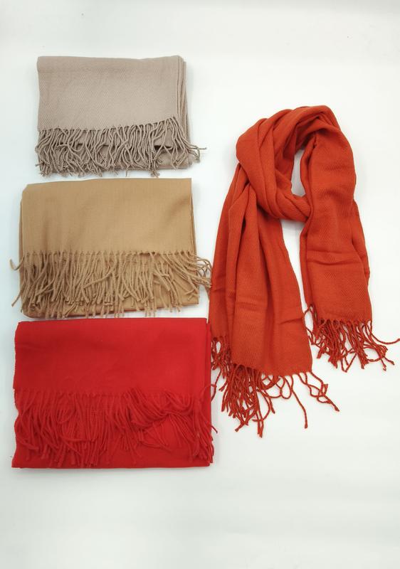 Cztery jednokolorowe szaliki pashmina z frędzlami w kolorach: beżowym, wielbłądzim, czerwonym i pomarańczowym.